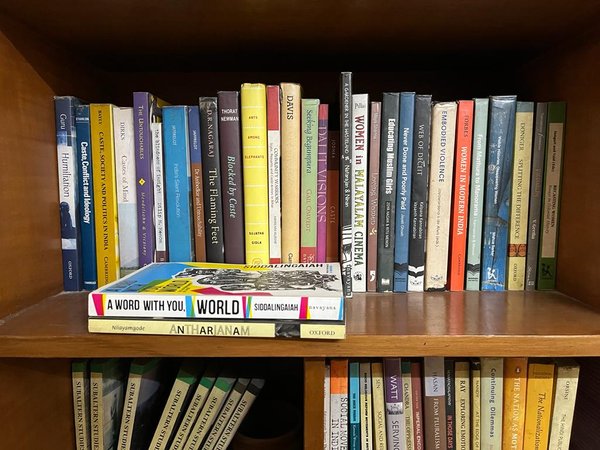 An image of several books on caste and gender on a shelf
