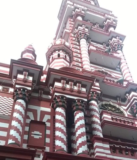 An image of a red and white striped building with a clock tower.